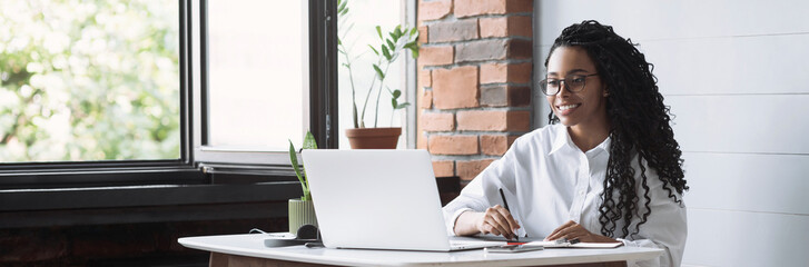 Young woman using laptop computer at office panoramic banner. Student girl working at home. Work or study from home, freelance, business, lifestyle concept