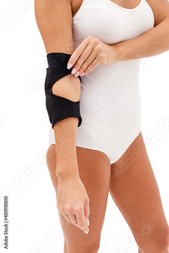 A Woman Wearing Elbow Brace Over White Background