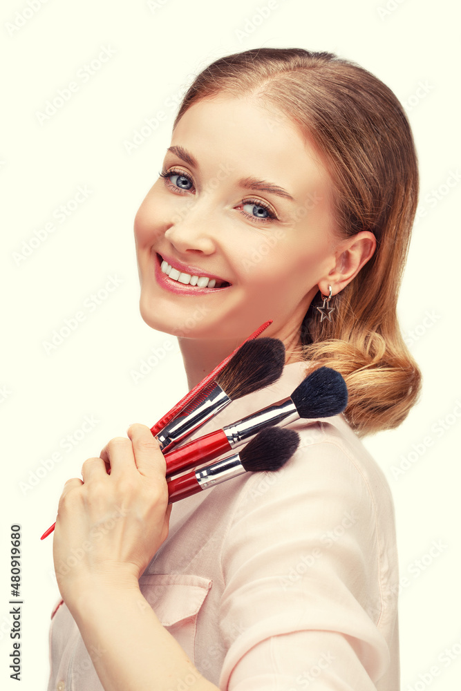 Make-up stylist, hairdresser on a white background. Girl with brushes and a comb in her hands Make-up stylist, hairdresser on a white background. Girl with brushes and a comb in her hands