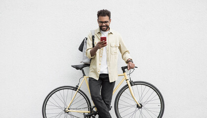 Young handsome man with bicycle over white wall background in a city, cheerful student men with mobile phone smiling outdoor, Modern healthy lifestyle, travel, casual business, connection concept