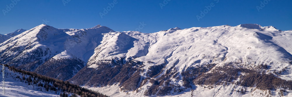 Stunning alpine panorama view of snowy peaks near the Italian ski resort town of Livigno