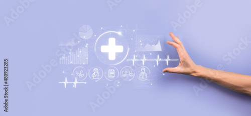 Businessman hold virtual plus medical network connection icons. Covid-19 pandemic develop people awareness and spread attention on their healthcare.Doctor,document,medicine,ambulance,patient icon.