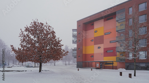 The center of Finnish Kerava town during winter fog: color in winter town, colored building, colored tree.