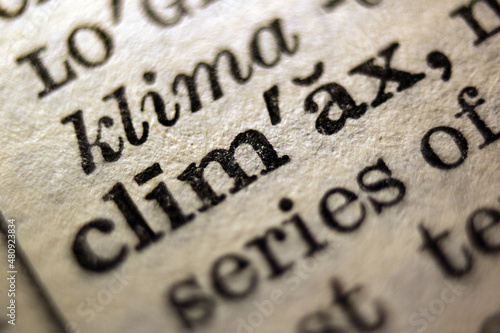 Φωτογραφία Word climax and violent printed on book page, macro close-up