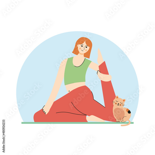 Young woman doing yoga exercises, practicing meditation and stretching on the mat with cat. a cat sits next to a girl who does yoga. 