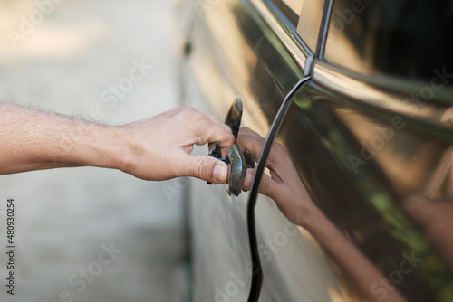 men hand open a car door 