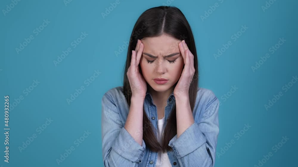 Frustrated lady touch temple covid infection isolated blue color background Frustrated lady touch temple covid infection isolated blue color background