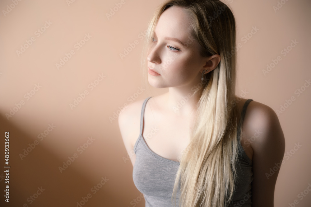 Fototapeta premium Portrait of a beautiful young woman with blue eyes.