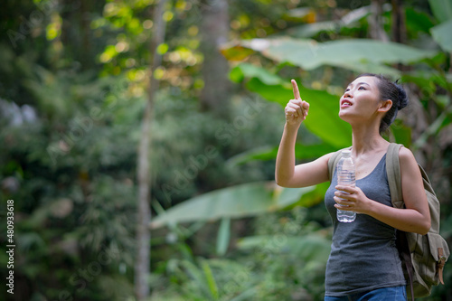 young woman attractive traveler adventure wilderness drink water.