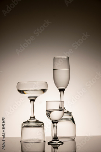 Glassware of different sizes against monochrome background