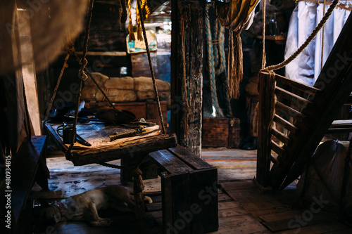 Wooden winch of a sailing ship and ropes on the deck of medieval pirate warship