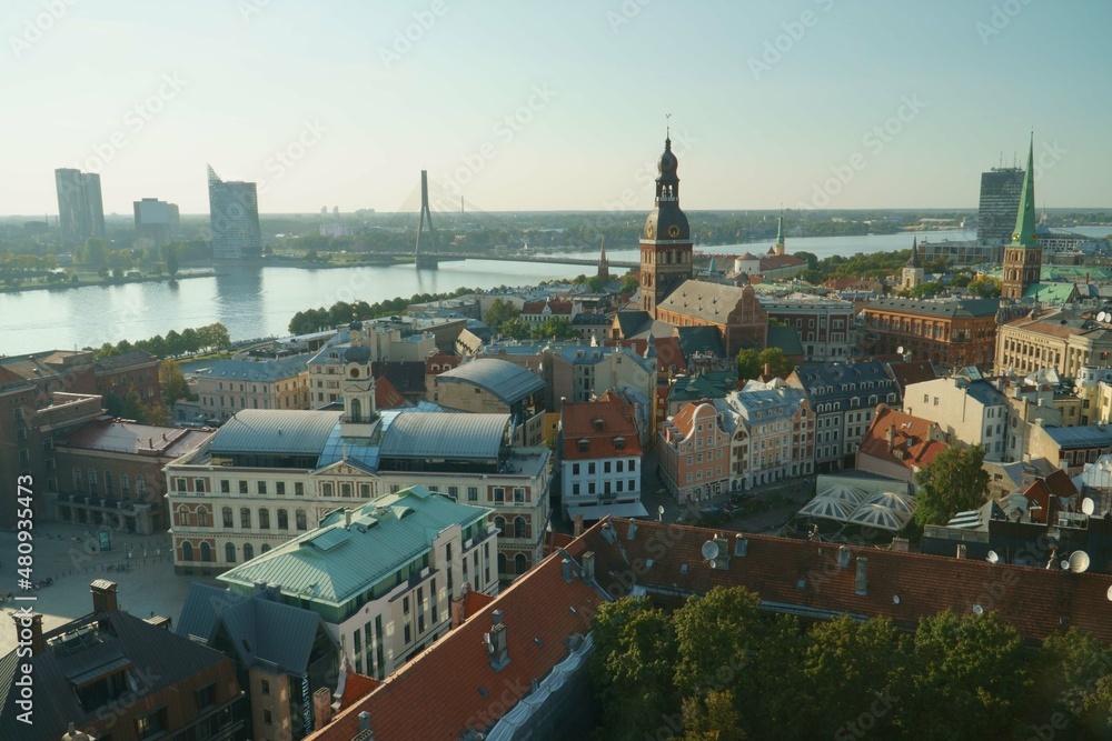 The Riga old town panorama aerial view at the Daugava riverside in Latvia. The beautiful panoramic landscape on a sunny peaceful day of summer. Landscape with church towers and historical buildings.