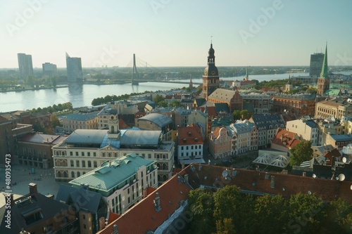 The Riga old town panorama aerial view at the Daugava riverside in Latvia. The beautiful panoramic landscape on a sunny peaceful day of summer. Landscape with church towers and historical buildings.