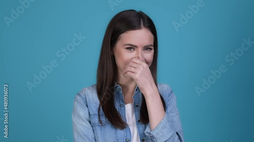 Lady not want her photograph hide face laugh isolated blue color background