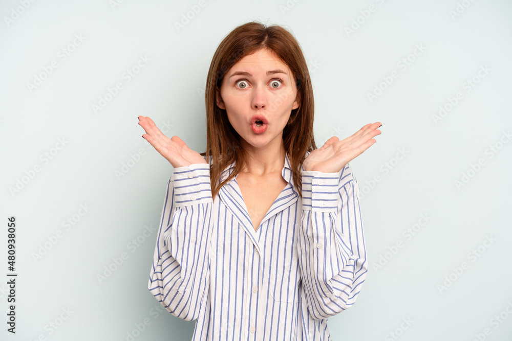 Young English woman isolated on blue background surprised and shocked. Young English woman isolated on blue background surprised and shocked.