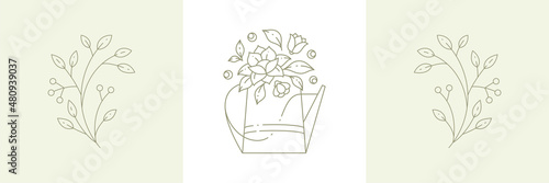 Linear simple flower bouquet with lotus in watering can and cranberry, lingonberry branches berries