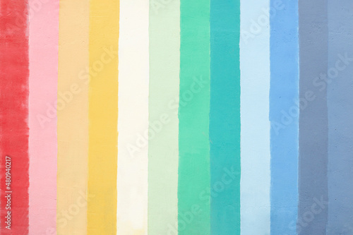 Colorful concrete wall texture background in bright rainbow colors pattern.