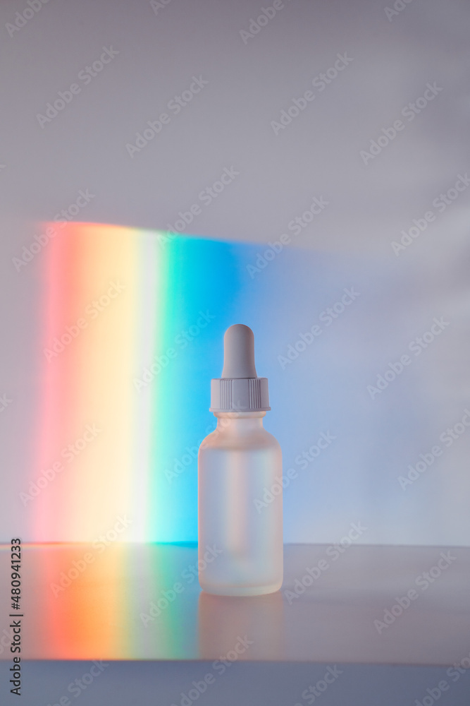 Face serum in front of rainbow Face serum in front of rainbow