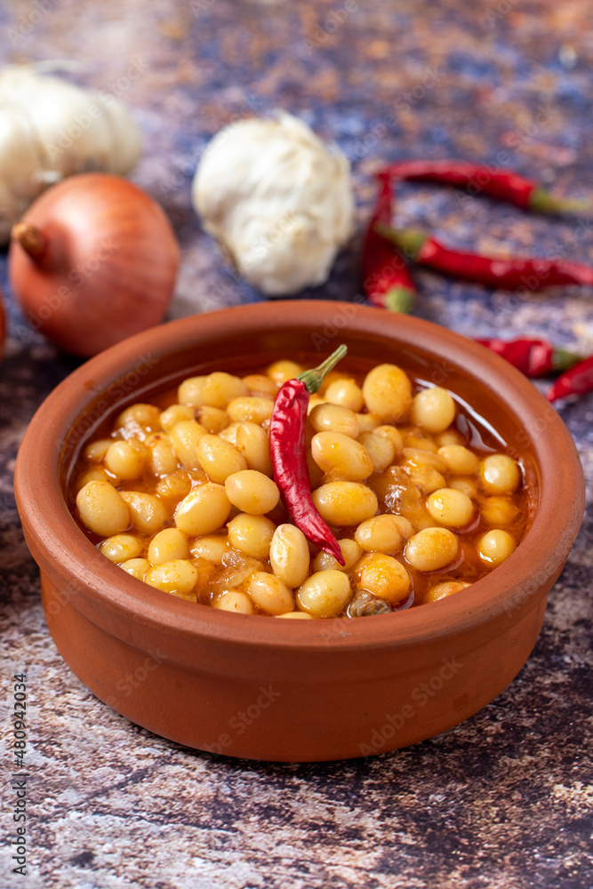 Hot turkish bean stew on wooden background. Ispir beans cooked in a casserole - Kuru Fasulye Hot turkish bean stew on wooden background. Ispir beans cooked in a casserole - Kuru Fasulye