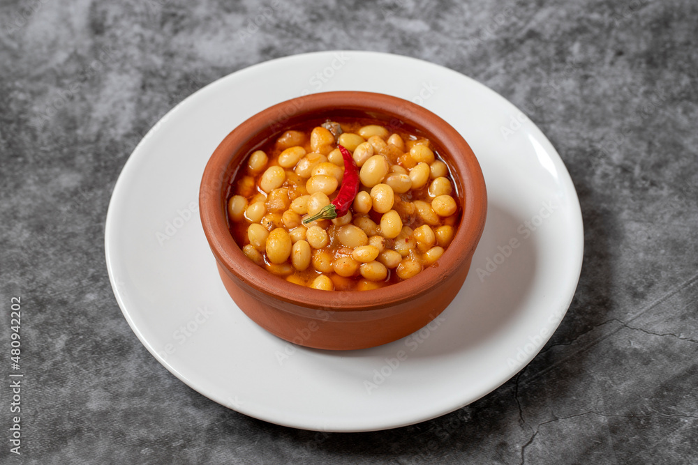 Hot turkish bean stew on dark background. Ispir beans cooked in a casserole - Kuru Fasulye Hot turkish bean stew on dark background. Ispir beans cooked in a casserole - Kuru Fasulye