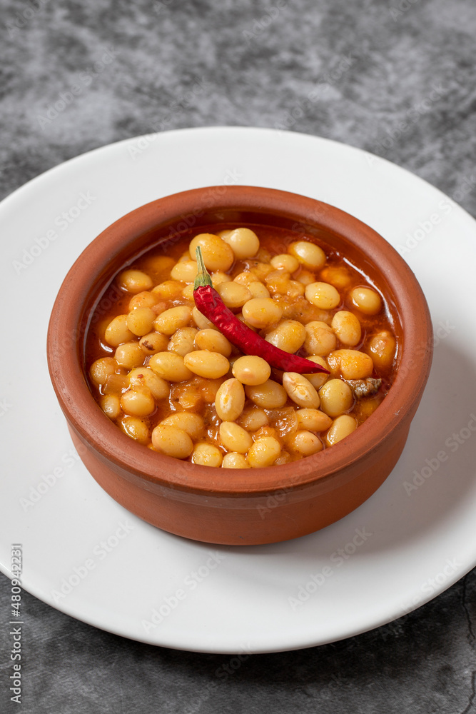 Hot turkish bean stew on dark background. Ispir beans cooked in a casserole - Kuru Fasulye Hot turkish bean stew on dark background. Ispir beans cooked in a casserole - Kuru Fasulye