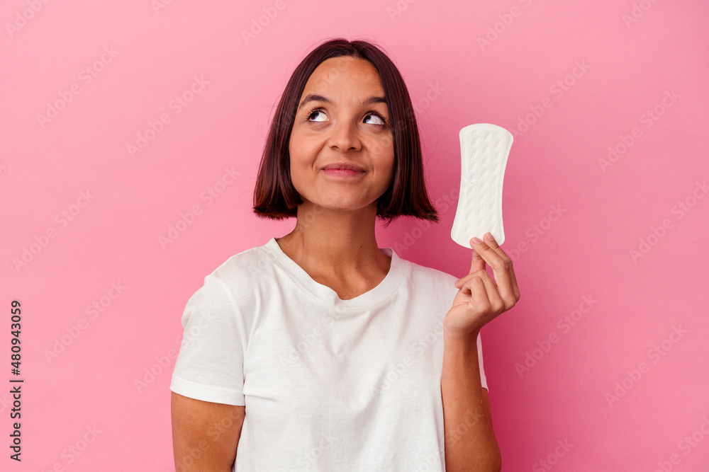Young mixed race woman holding a compress isolated on pink background dreaming of achieving goals and purposes Young mixed race woman holding a compress isolated on pink background dreaming of achieving goals and purposes