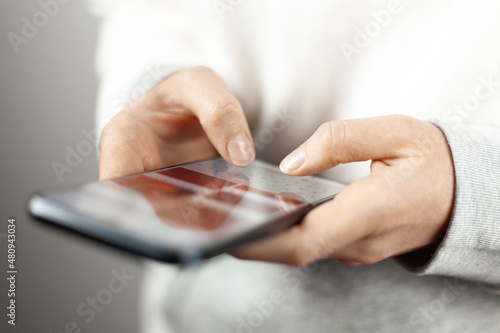 Online order on the phone. Close-up, the user's hands with a smartphone.