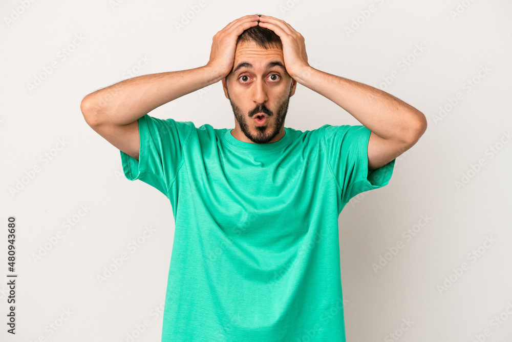Young caucasian man isolated on white background surprised and shocked. Young caucasian man isolated on white background surprised and shocked.