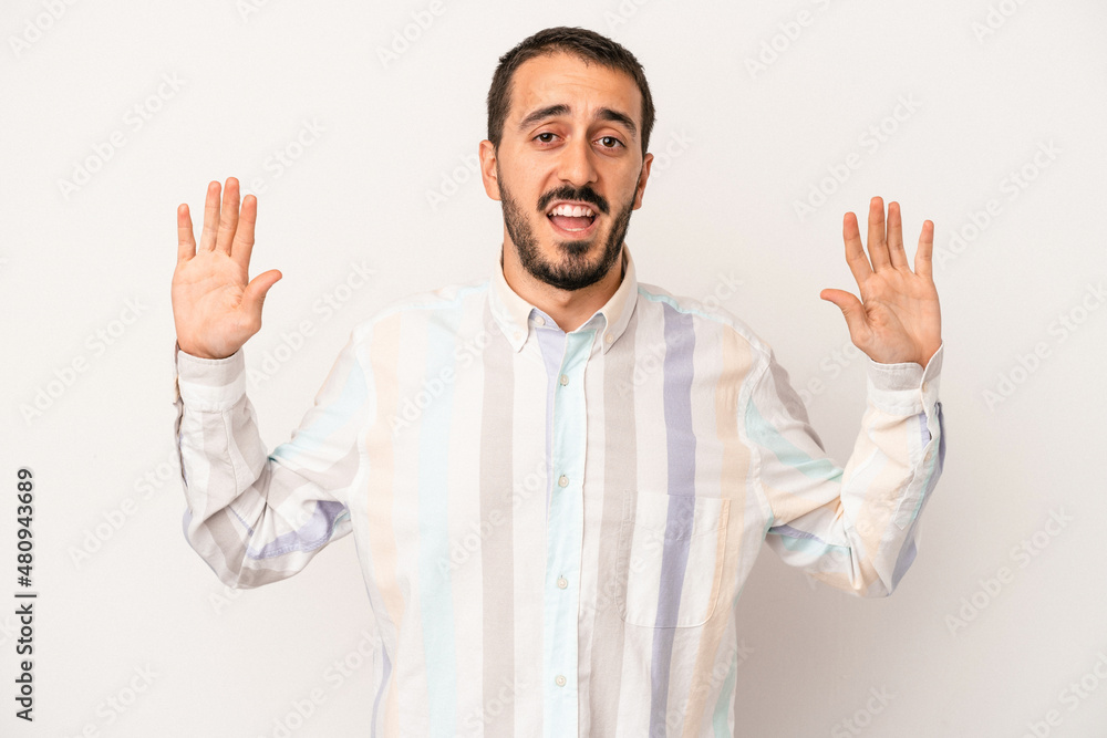 Young caucasian man isolated on white background being shocked due to an imminent danger Young caucasian man isolated on white background being shocked due to an imminent danger