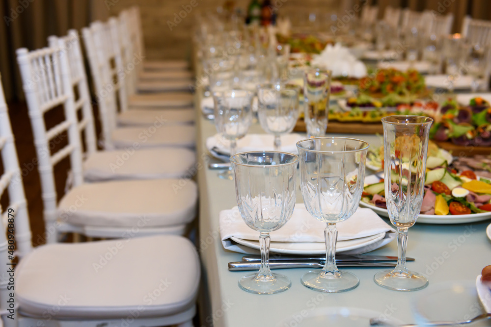 Banquet table served for guests. Cutlery and food at the reception party. Banquet table served for guests. Cutlery and food at the reception party.