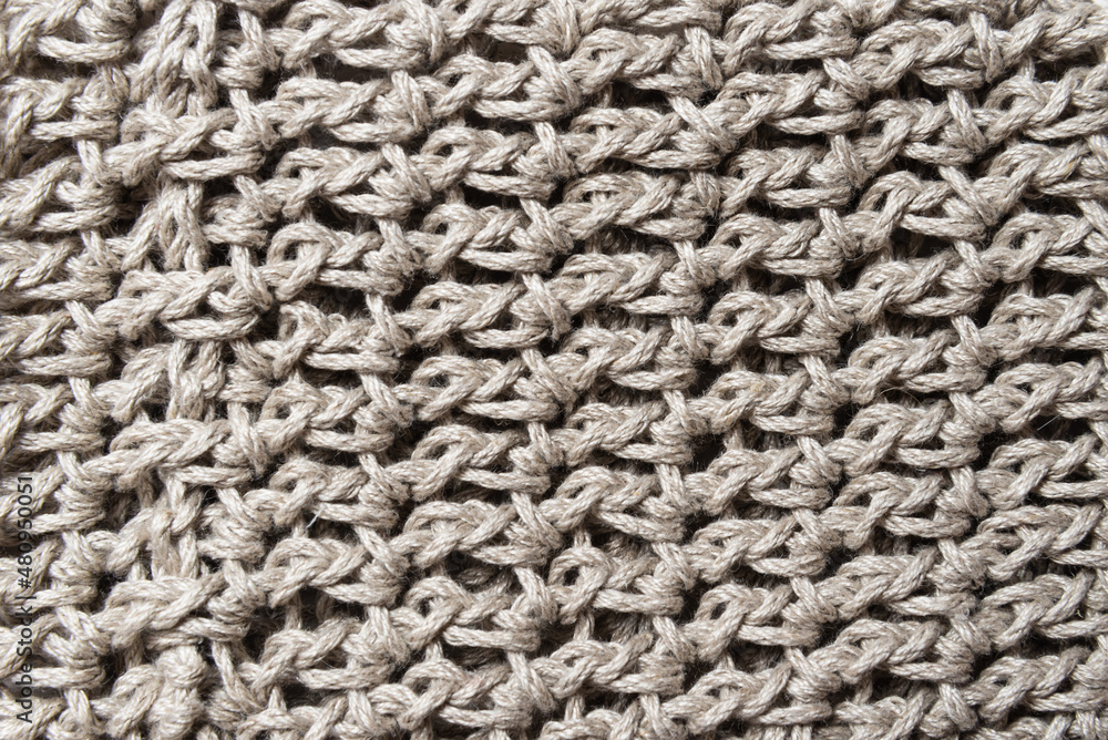 Grey yarn knitted crocked fabric textured background