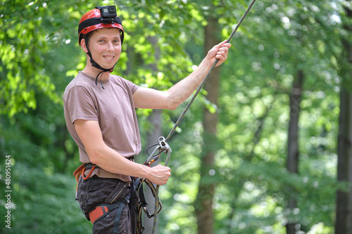 Man belays his partner climber with belaying device and rope. Climber's handsman holding equipment for rock mountaineering security photo