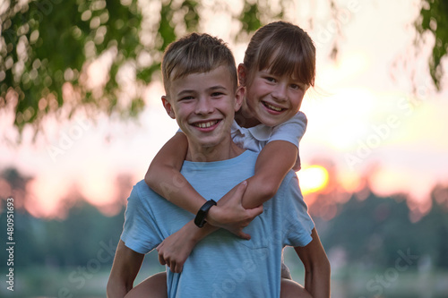 Papier peint Happy siblings hugging lovingly in summer park