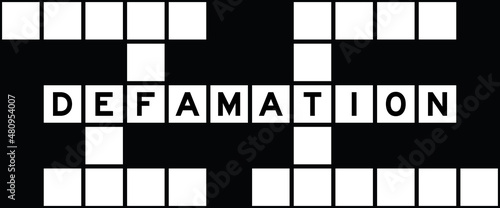 Alphabet letter in word defamation on crossword puzzle background