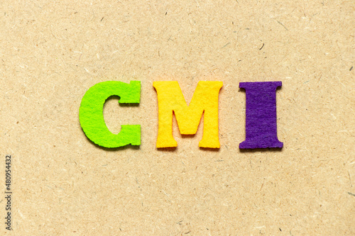 Color cloth alphabet letter in word CMI (Abbreviation of Cost management index, Co-managed inventory,Customer Managed Inventory or case mix index) on wood background