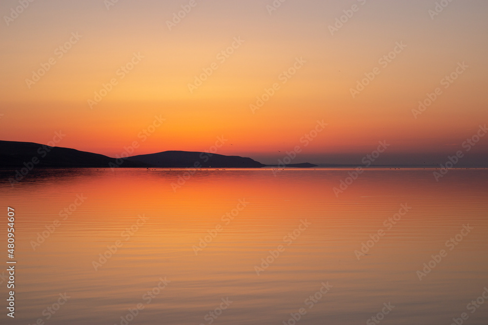 beautiful sunrise on the lake. The moment when the sun has not yet risen above the horizon beautiful sunrise on the lake. The moment when the sun has not yet risen above the horizon
