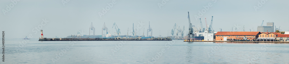 Panoramic view of sea port of Thessaloniki city with lots of cargo cranes. Water shipment and transport in Greece concept