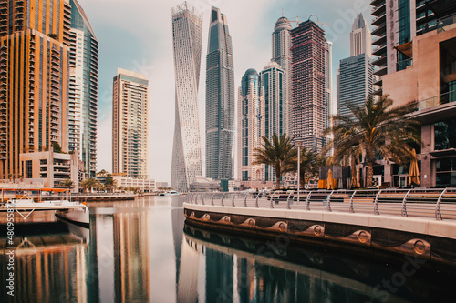 DUBAI, UAE - FEBRUARY 2018: View of modern skyscrapers shining in sunrise lights  in Dubai Marina in Dubai, UAE. photo