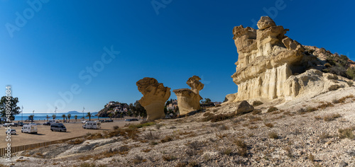 sandstone cliffs and many camper vans at the beach in Bolnuevo photo