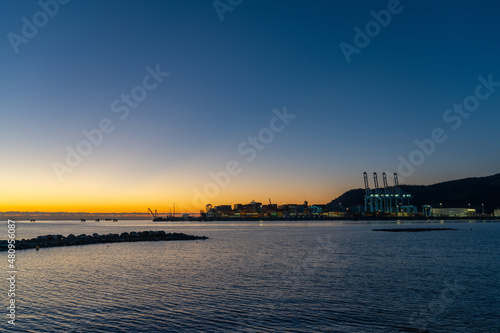 view of the industrial port and harbor of Vado Ligure at sunrise