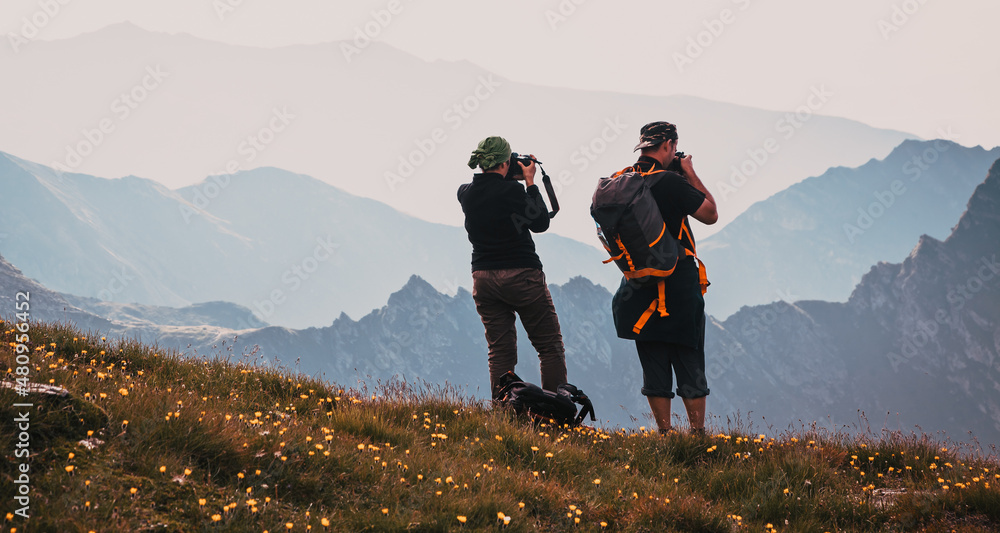 hiker couple enjoying high mountains view