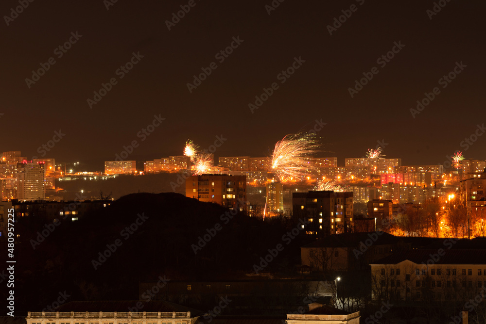 Fireworks in the city at night during New Year celebration. Soft focus background