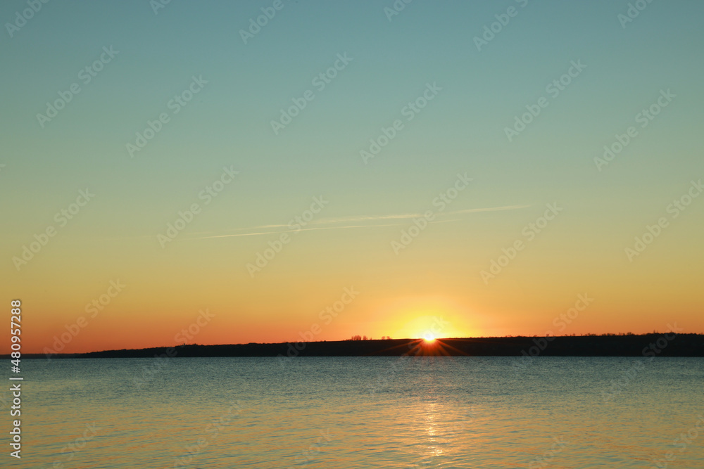 Obraz premium Picturesque view of beautiful sunset over calm river