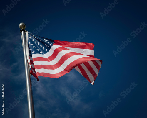 фотографія Flag of the United States of America against a blue sky.