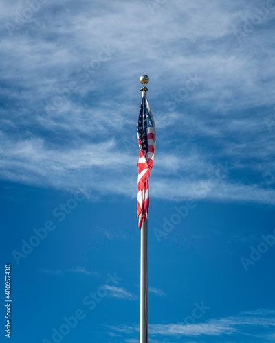 фотографія Flag of the United States of America against a blue sky.
