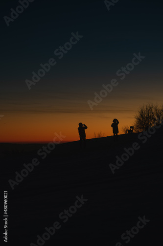 silhouettes of people taking photos