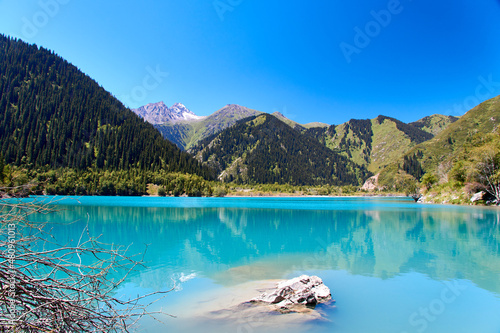 scenic view of the mountain lake and the slopes of the mountains covered with fir trees