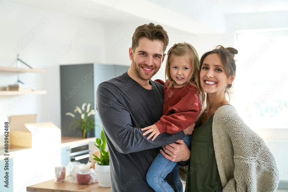 Portrait of happy caucasian family with daughter in a new apartment Portrait of happy caucasian family with daughter in a new apartment