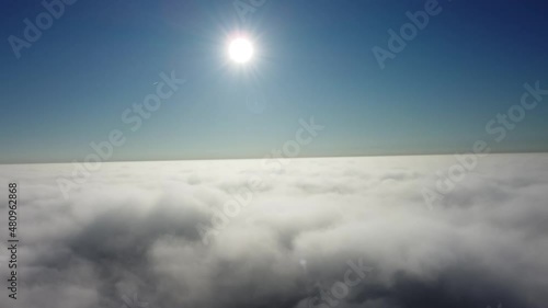 Sun is rising above the endless sea of clouds until the horizon. Amazing nature landscape, 4K drone in sky