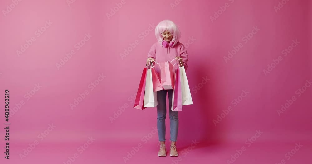 Happy Girl after successful shopping isolated on pink background studio portrait Happy Girl after successful shopping isolated on pink background studio portrait